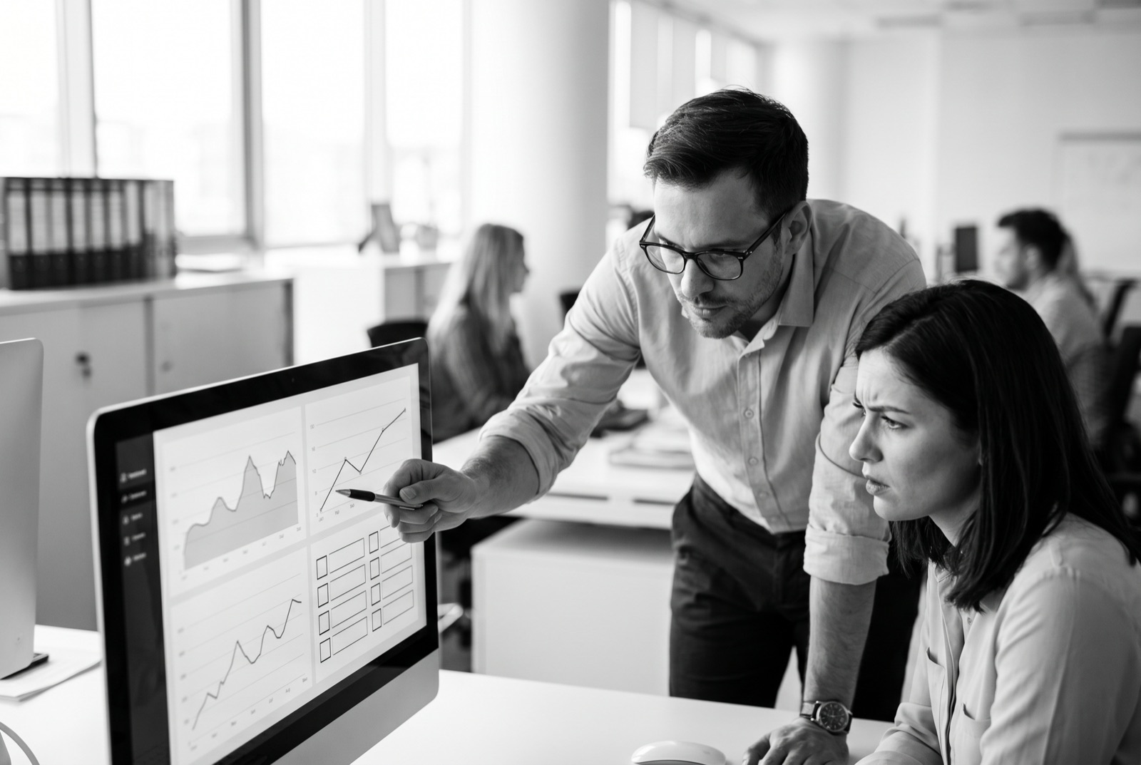 Two specialists reviewing systems on a dashboard