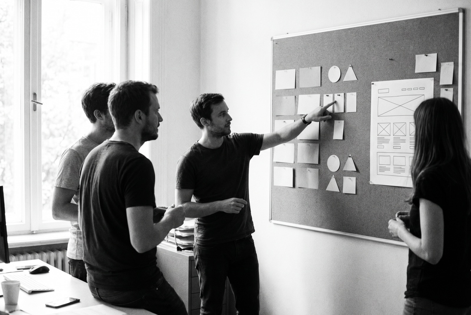 A creative team reviewing brand and messaging work on a board