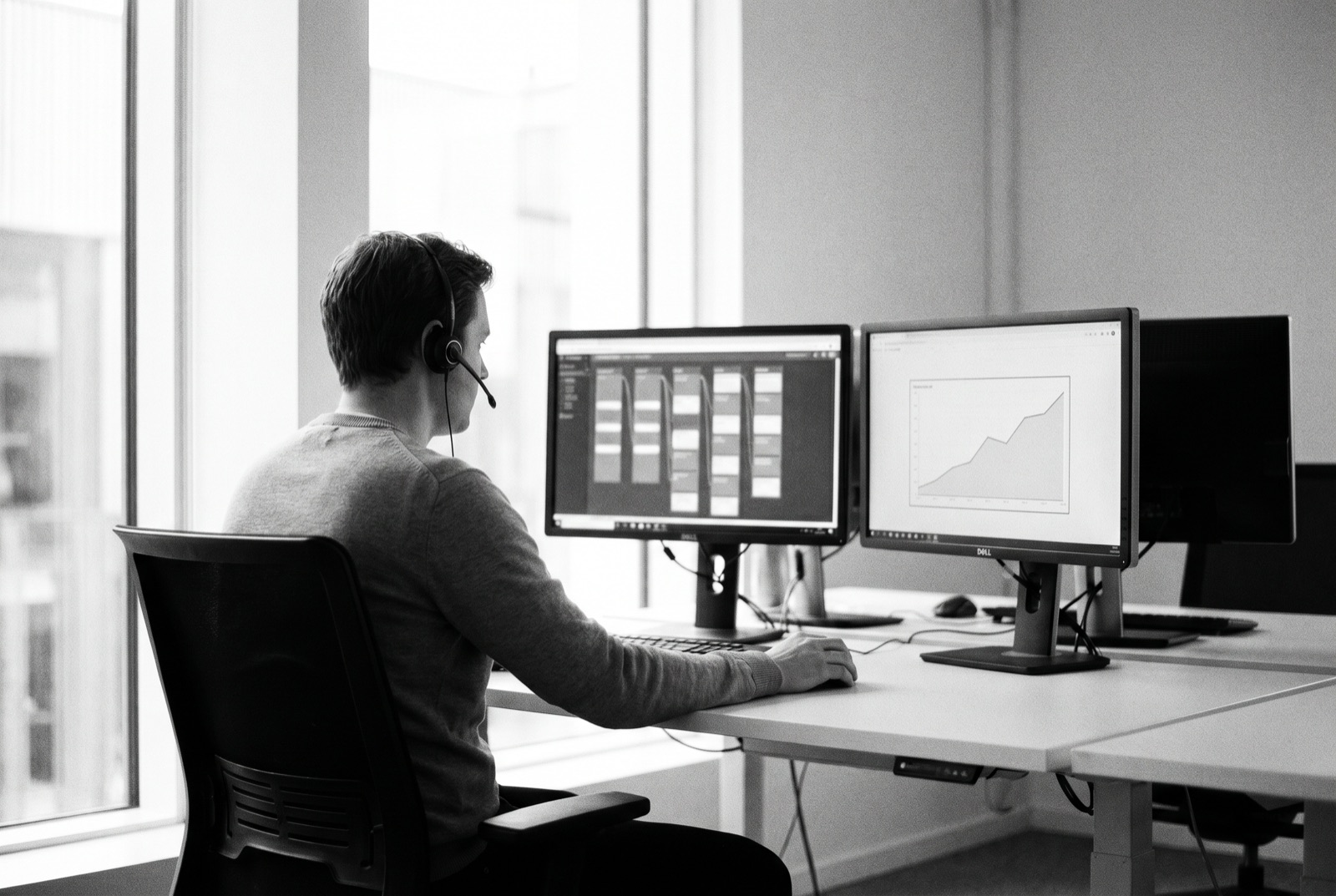 A support specialist monitoring site status at a desk