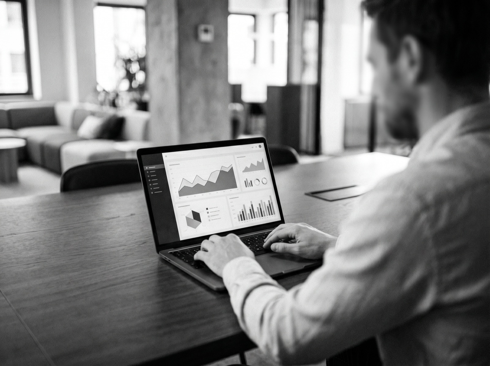 A marketer reviewing an analytics dashboard on a laptop